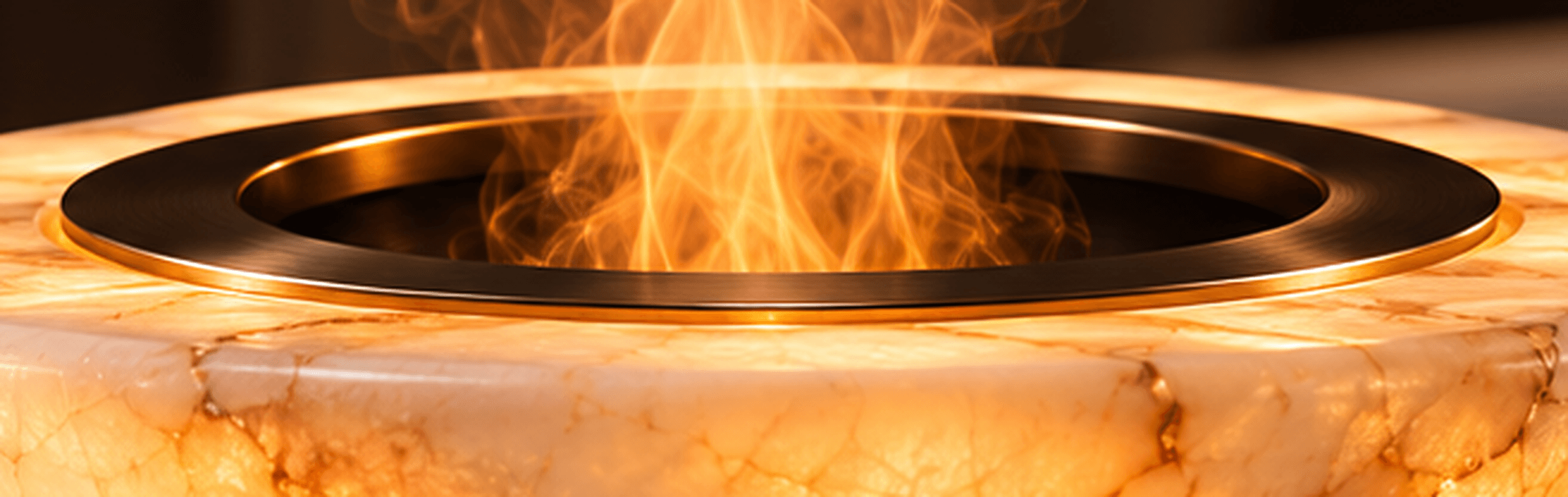 Close-up concept render of the ORUELLE brushed bronze ring around the recessed dark opening, with warm illuminated mist rising.